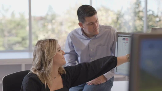 Will Elnick reviewing information on a computer with a colleague